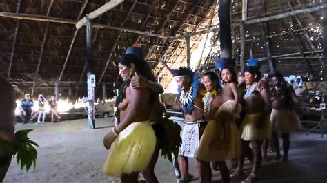 Cheerful young people throwing colorful powder in air, dancing at festival. Indian Dance Ceremony by Dessana Tribe in Tupe Amazon ...