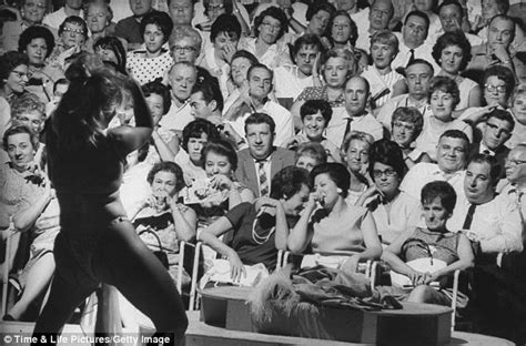 Black male stripper does backstage prep with women helping. Putting on a show: Classic burlesque pictures show the ...