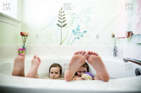 Free shipping and free returns on prime eligible items. Two kids in the bathtub with feet up stock photo - OFFSET
