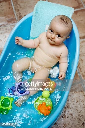 Grab a change of clothes, a clean diaper, a couple of washcloths, another big towel, a mild baby soap, and a bowl or cup of warm (not hot) water. 8 Months Baby Boy Taking A Bath High-Res Stock Photo ...