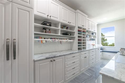 Gallery of craft room storage cabinets. This large crafting room features a wrapping station with ...