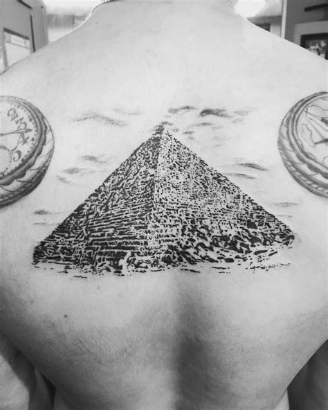 Grey ink egyptian eyes and ankh egyptian tattoo on back. 18 Refreshing Pyramid Tattoos to Try | Pyramid tattoo ...