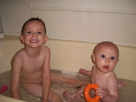 Haveing fun getting wet in a bathtub fully clothed. Our Growing Boys!: BathTime Fun!