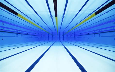 The flag of the olympic games has five linked rings on a white background. An underwater view of the London Olympics swimming pool : pics