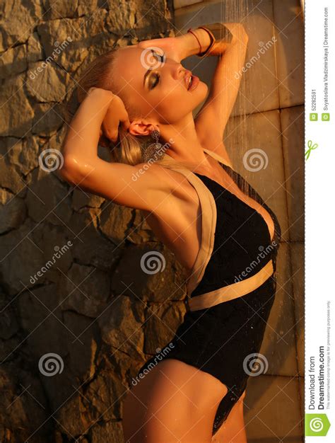 After shower she dries her body and dresses her casual clothes. Blond Woman Taking Shower On Sunset Beach Stock Photo ...