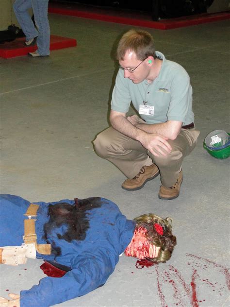 Hand of serial killer stabbing victim multiple times with a knife, crime scene. The List: Photos from the Mock Crime Scene