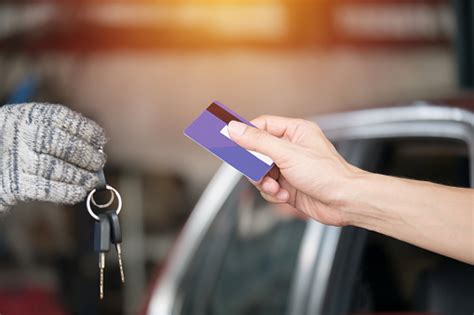 Pay for car with credit card. Customers Pay Car Repairs By Credit Card At Car Repair Center Stock Photo - Download Image Now ...