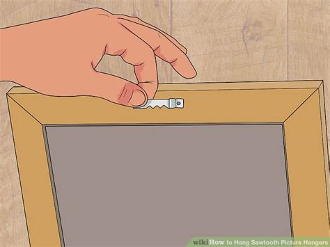 Find the center of the picture and center of the painters tape, and mark it with a pencil. Easy Ways to Hang Sawtooth Picture Hangers: 10 Steps