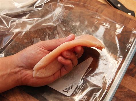 To protect your hand, fold a kitchen towel and place it on top of a heavy, sharp knife. Pin on chicken