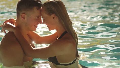 Enchanting young gal licked by pold boy. Attractive Couple Swimming In The Pool In European Hotel ...