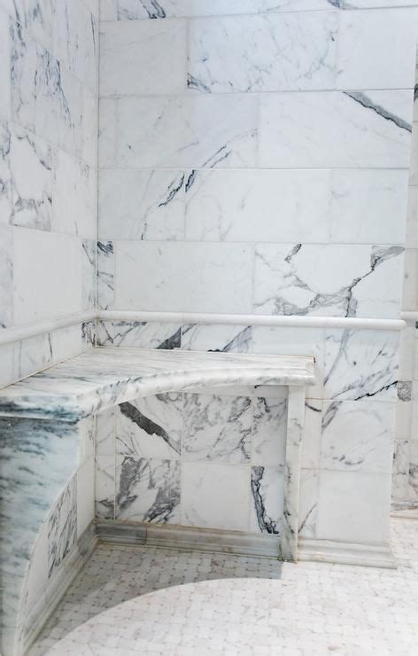The floor with an inset basket weave of carrara marble and black granite dots is one of the final touches that infuses old world opulence into this master bathroom. Fantastic shower is filled with carrera marble tiles ...
