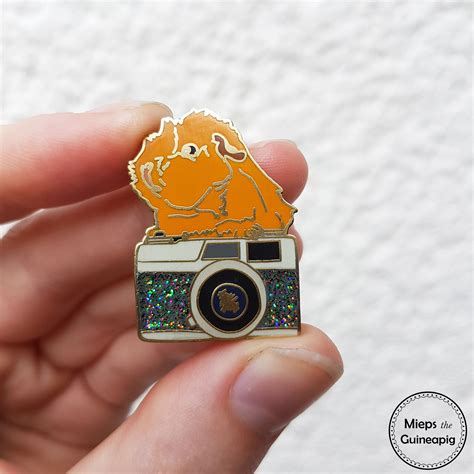 Things like backpacks, designer bags, and baseball. Enamel Pins - Story of a guinea pig