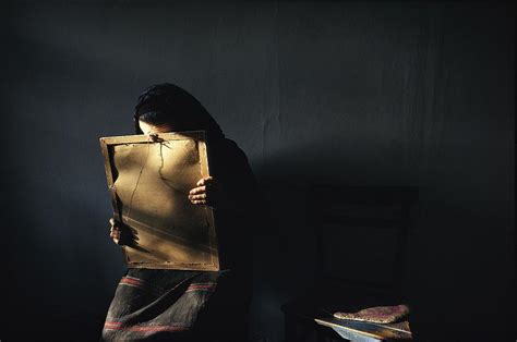 A Grieving Woman Holds A Photograph Photograph by James L Stanfield