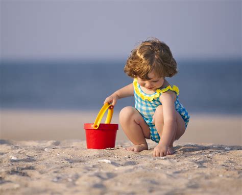 Happy kids building sand castles and playing beach ball. Breakdown of the Perfect Squat: How to Squat in 5 Simple Steps